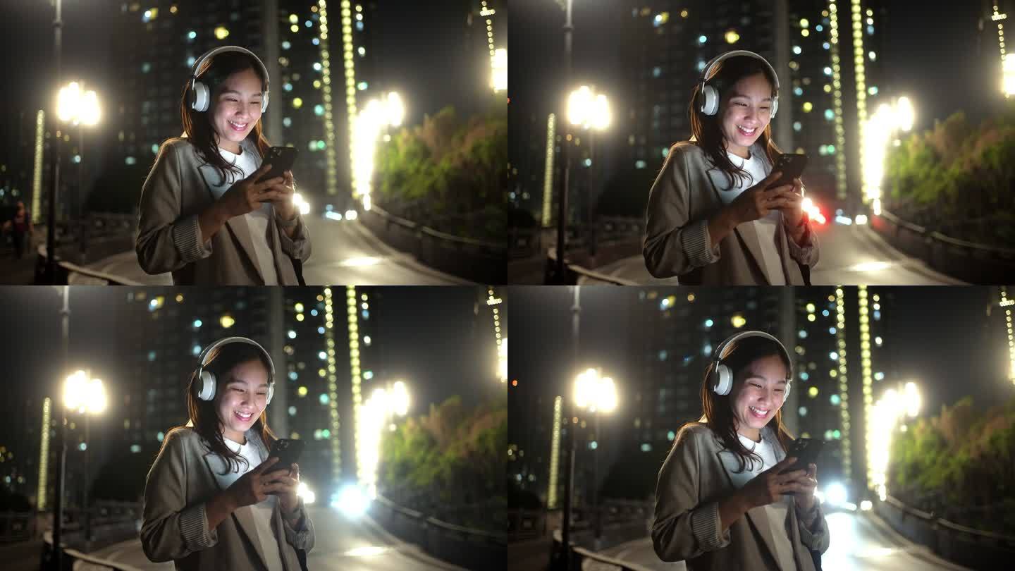 亚洲女性晚上下班后用智能手机听音乐