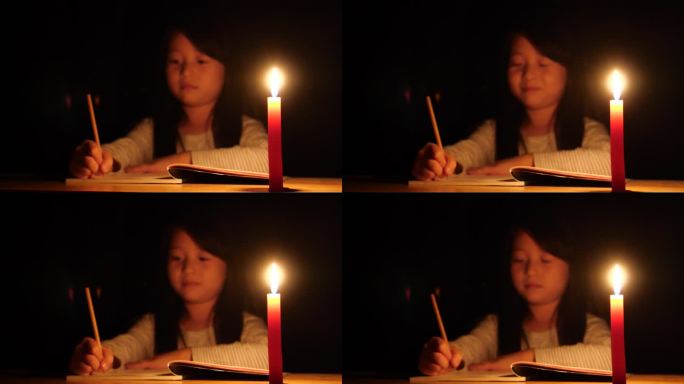 儿童小女孩写作业写信点蜡烛