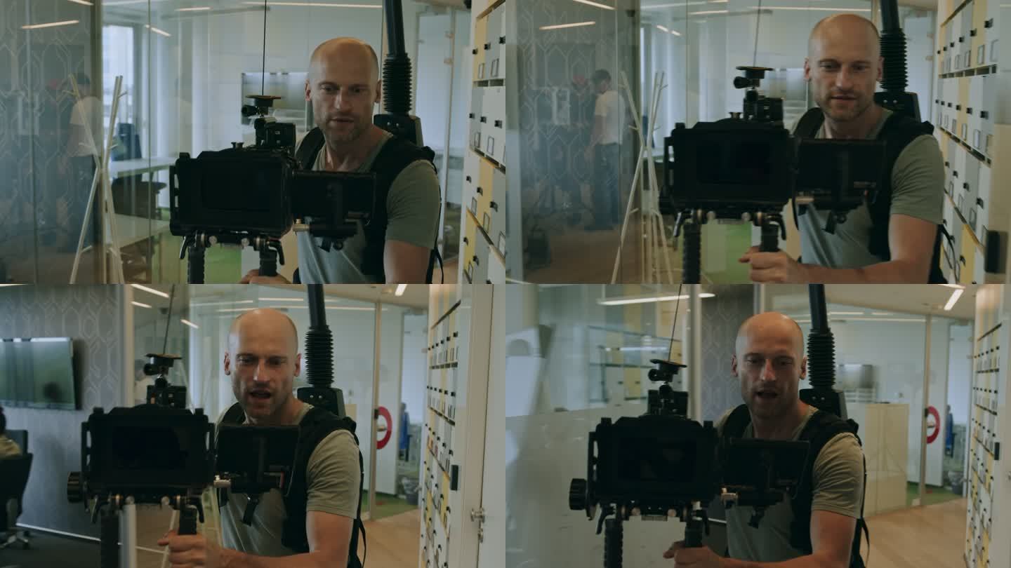 操作员使用相机和稳定器拍摄。办公室内部