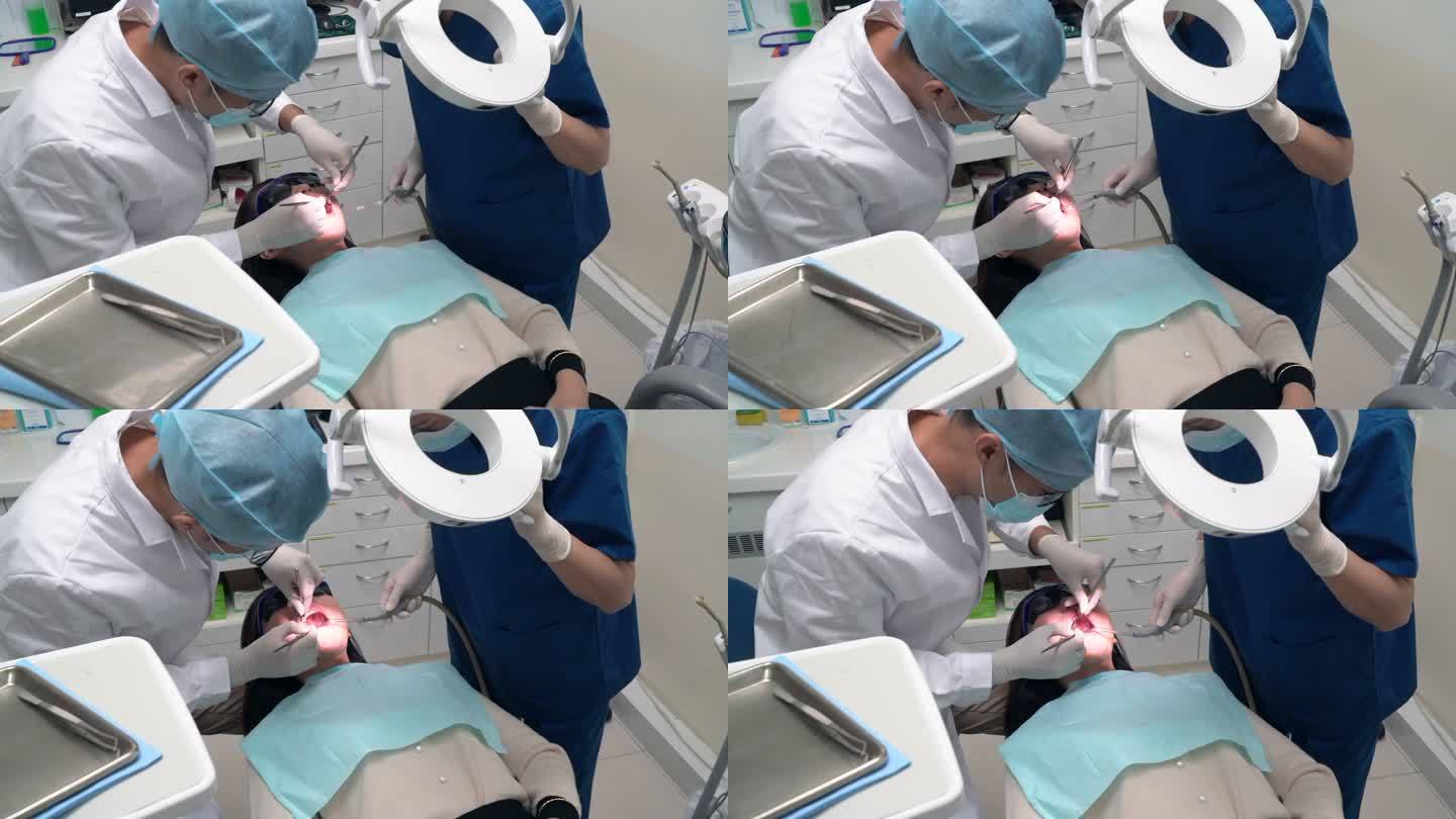 牙科护理-亚洲牙医检查患者的口腔状况