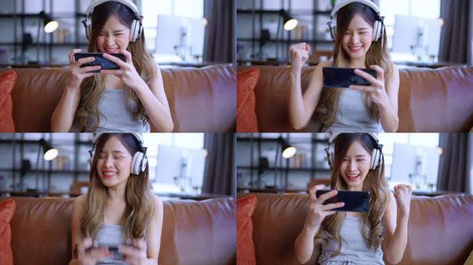 兴奋的微笑着的年轻成年亚洲女性戴着耳机，在家里沙发上用智能手机在线玩电子竞技游戏远程隔离封锁期家庭内