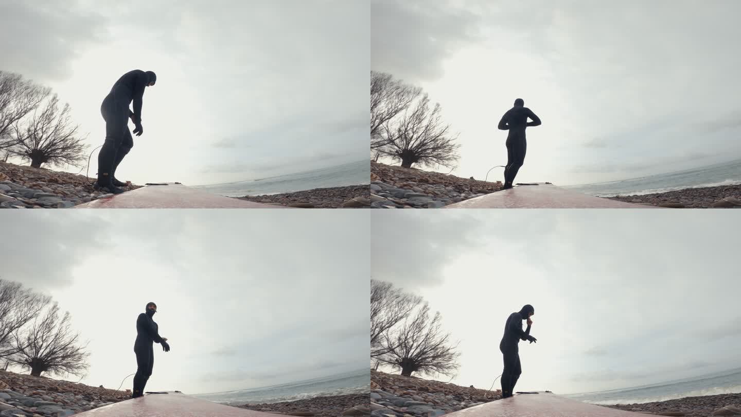带动作摄像机的冬季冲浪pov：长板上的男子