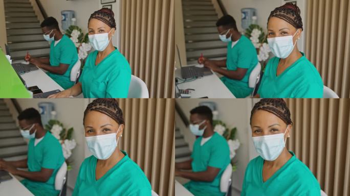 医务人员戴着防护面罩坐在医务室护士站的照片