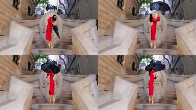 美丽的芭蕾舞演员撑着伞在古老的石头楼梯上跳舞。伊斯坦布尔的卡蒙多楼梯