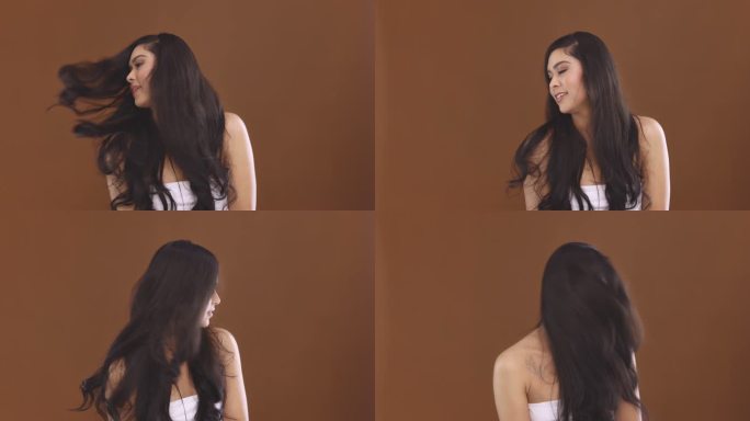 4k视频片段，一位迷人的年轻女子在工作室背景下乱扔头发