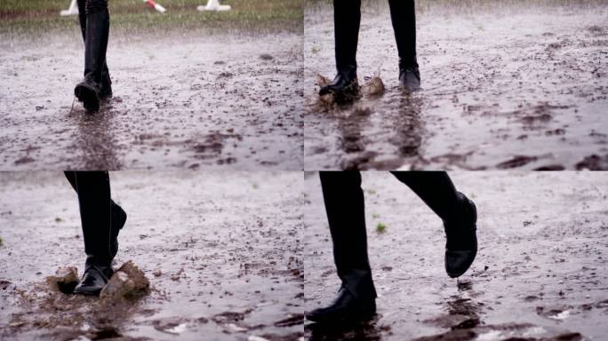骑师靴特写镜头大雨中行走泥泞