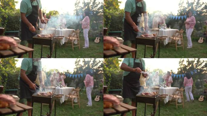 在后院的聚会上，一位老人在为他的朋友烧烤