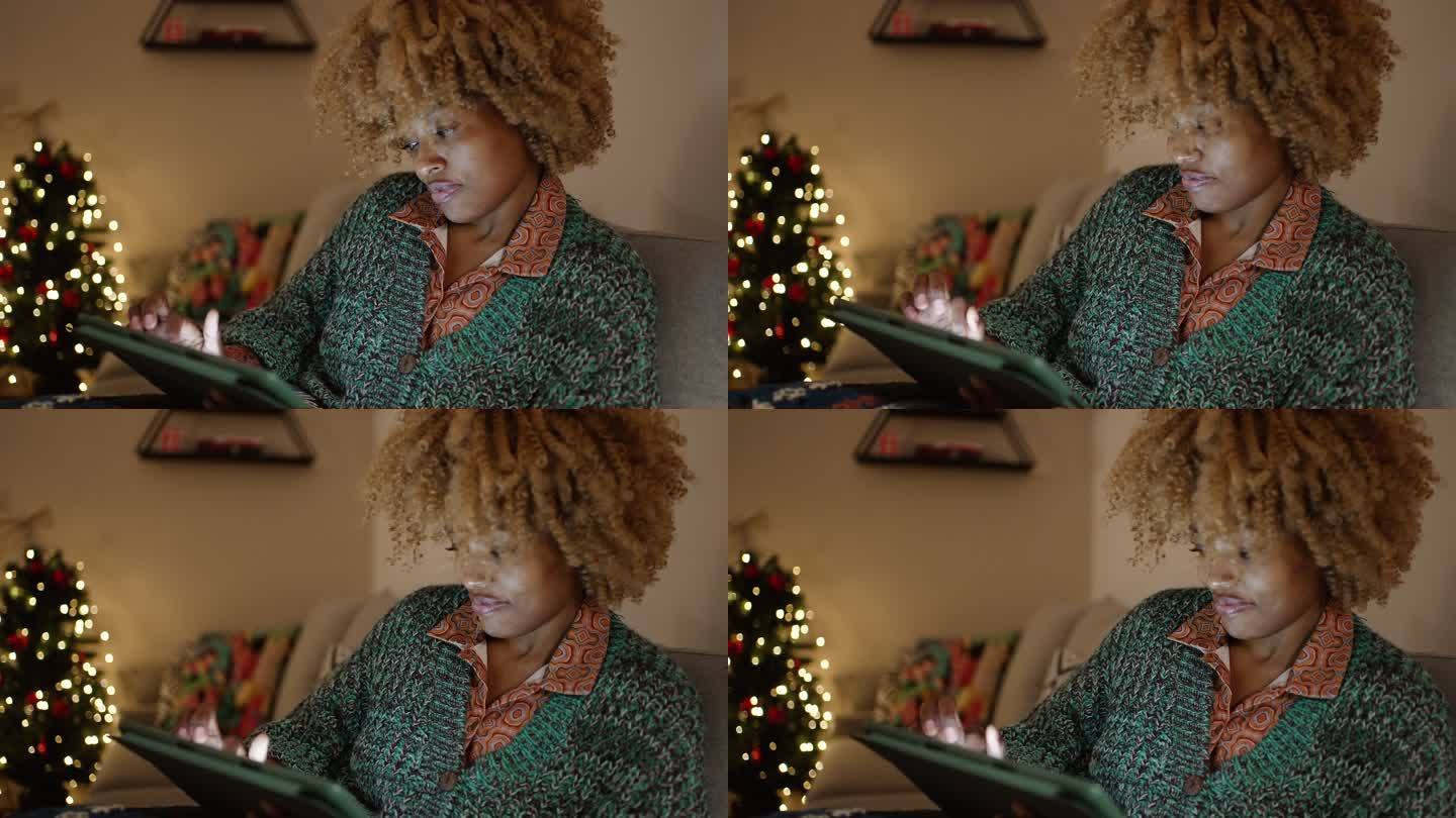 在数字平板电脑上进行网上圣诞购物的女人
