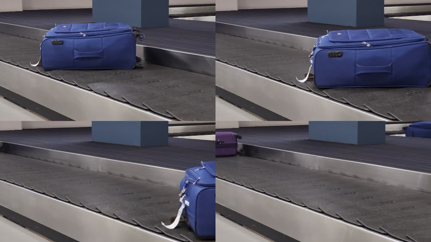 在机场行李提取区的行李传送带上移动的旅行包热