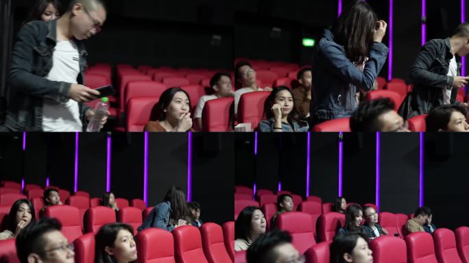 在电影放映期间，进入电影院大厅的亚裔中国夫妇经过其他观众到达座位