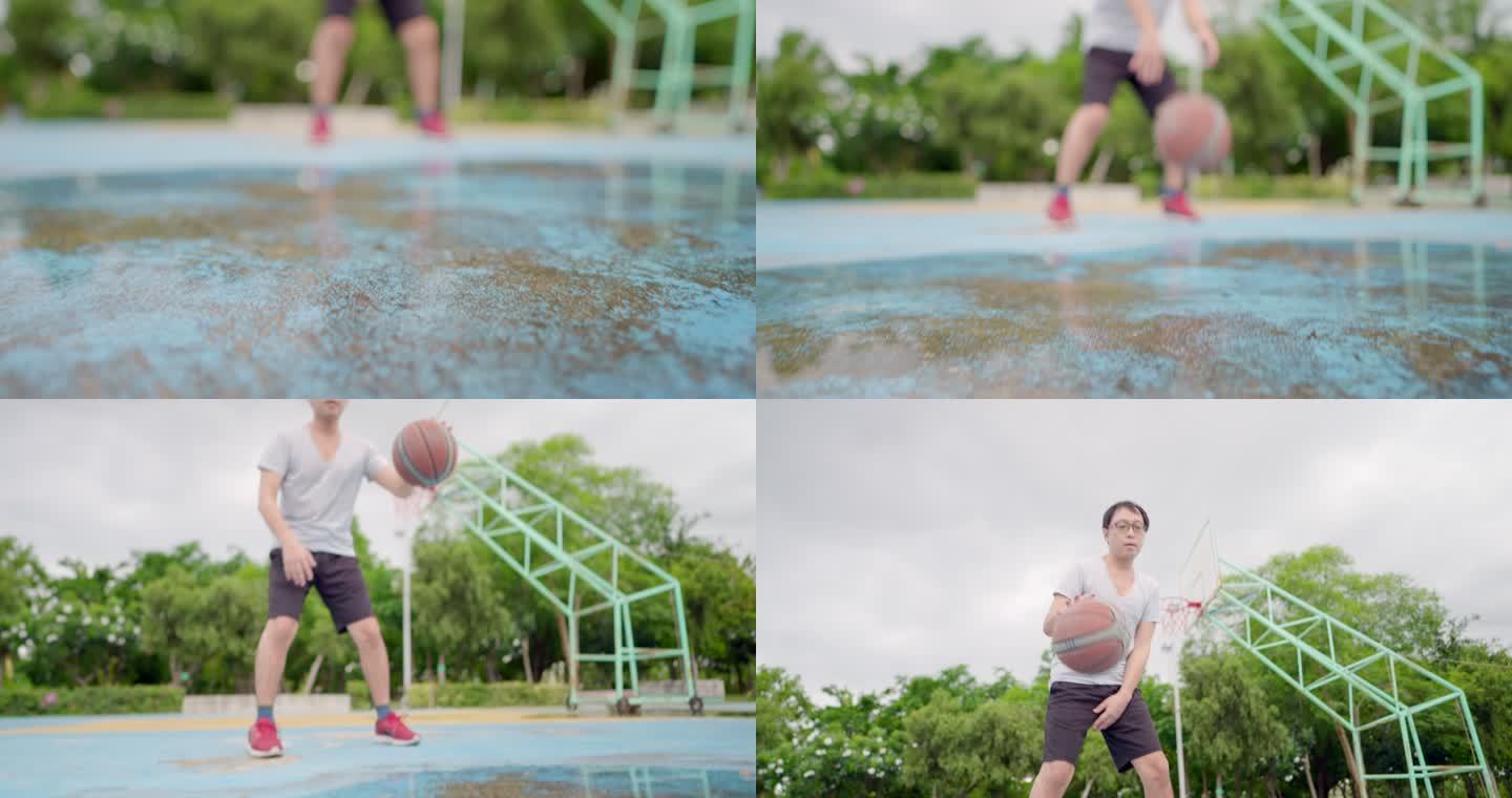 平移镜头。亚洲年轻男子在户外球场打篮球，玩得很开心。日落时分，男子篮球运动员在球场上通过左右手交替练