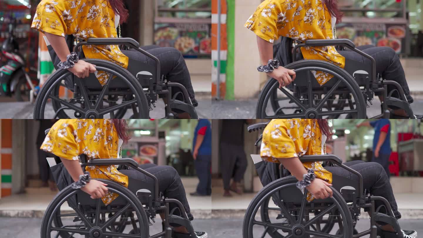 路边使用轮椅的亚洲印度残疾美女侧视图