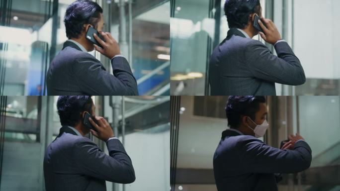 商人在机场使用手机。