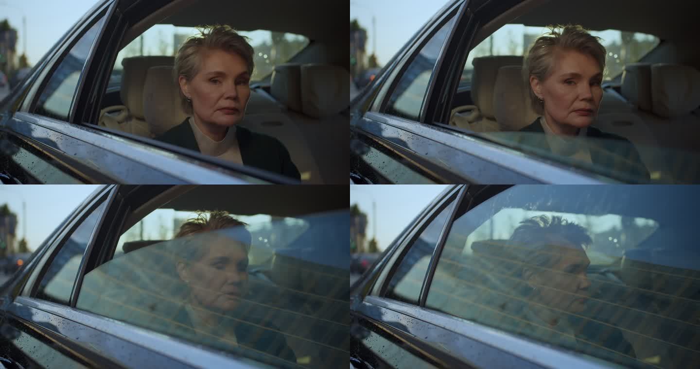 近距离观察一位愤怒的中年女性，坐在汽车后座，关上车窗