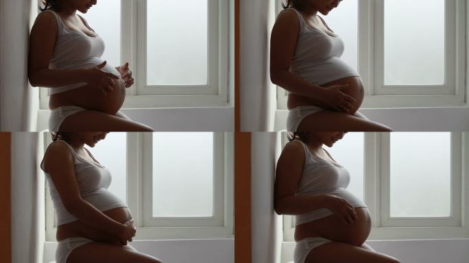 带窗灯的孕妇孕妇窗台摸肚子母爱