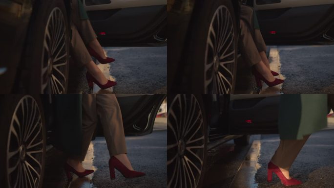 穿着时髦的红色高跟鞋和米色裤子的女性脚优雅地从黑色汽车上下来
