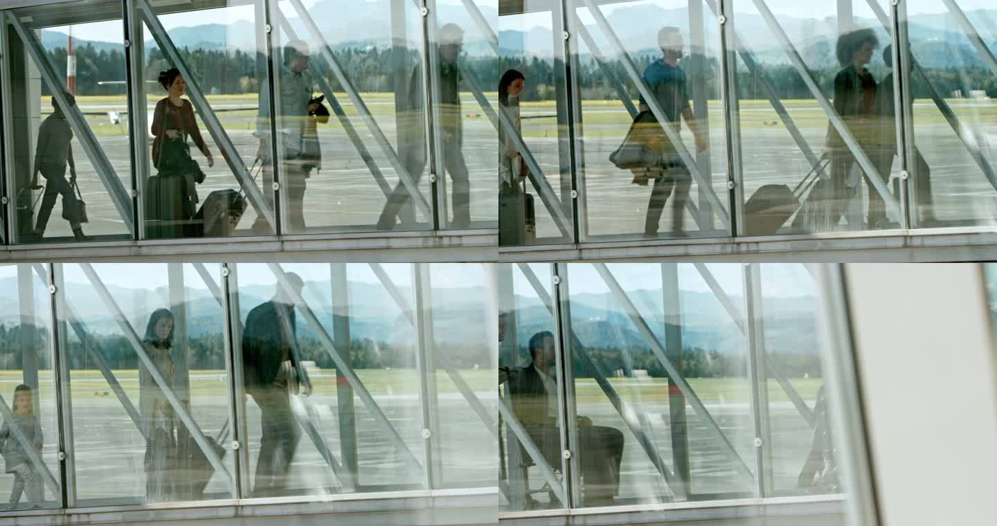 乘客在玻璃喷射桥上离开飞机