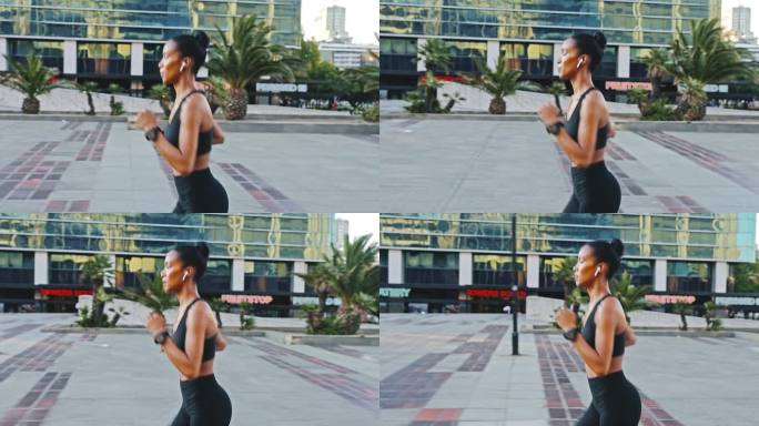 城市里的混血女子慢跑。女运动员早上锻炼。积极参加有氧运动的人