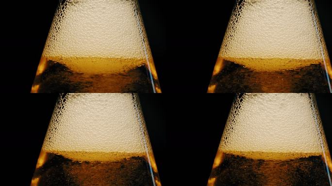瓶中啤酒泡沫的特写镜头。