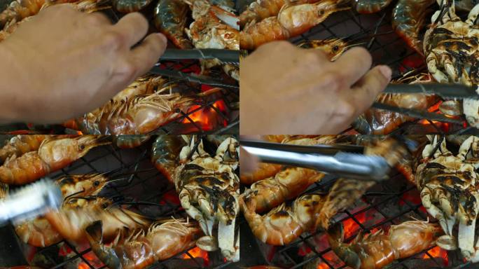 烤架上的虾和蟹烤虾翻面烧烤