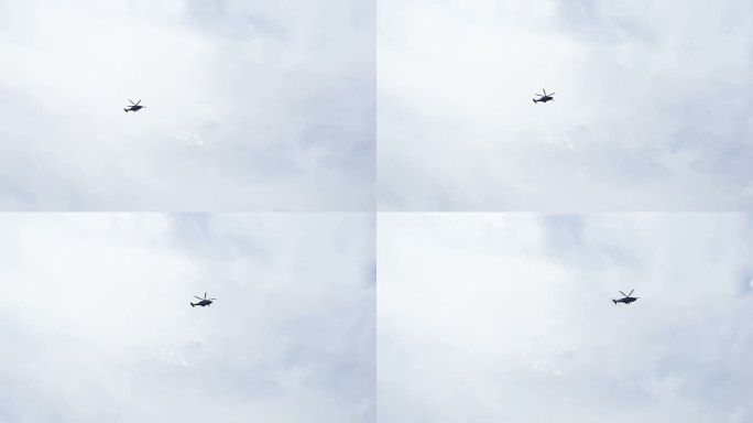 直升飞机在天空中迎云飞行