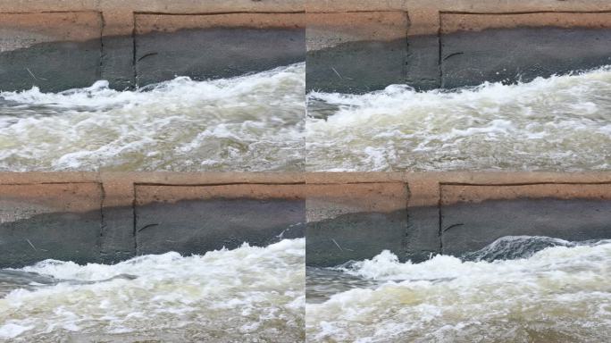 通过运河中的混凝土屏障看到的剧烈湍流。