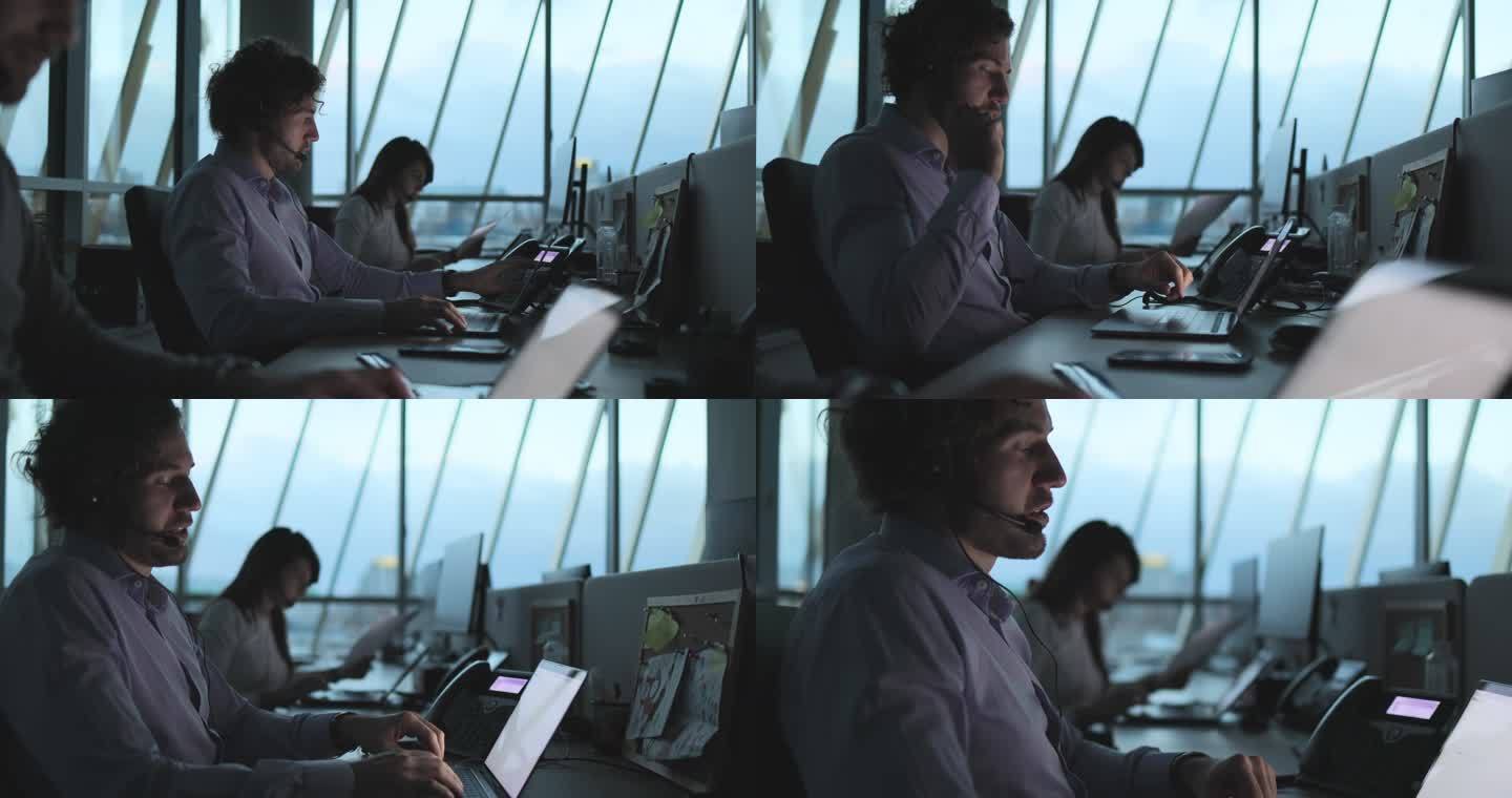客户服务代表在呼叫中心的台式PC上工作