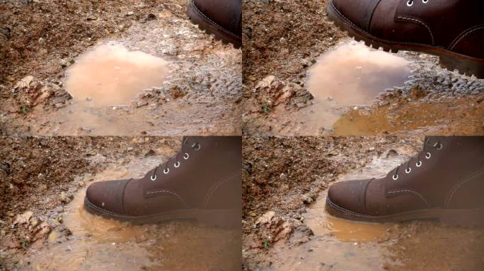 慢动作靴子踩在雨水坑里溅起水花