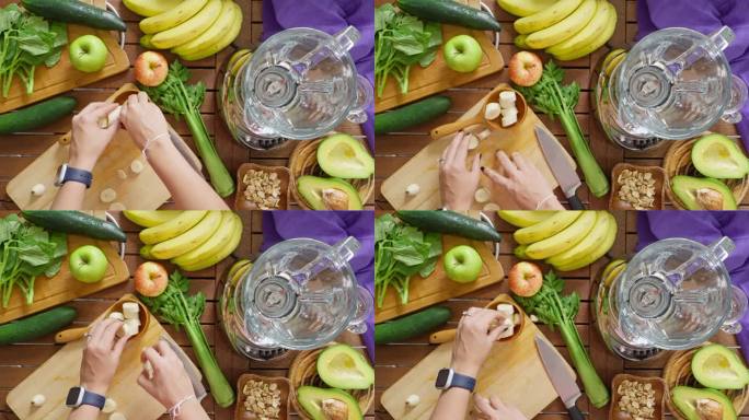 正上方拍摄的女子切割香蕉以混合蔬菜和水果以制作排毒奶昔的慢动作。