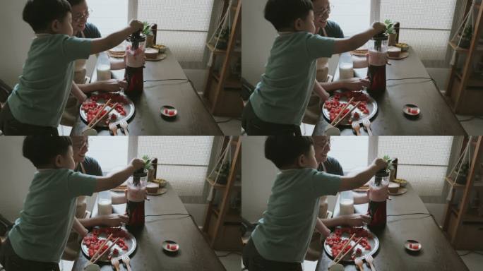 可爱的亚洲男孩拿着搅拌机搅拌西瓜奶昔。
