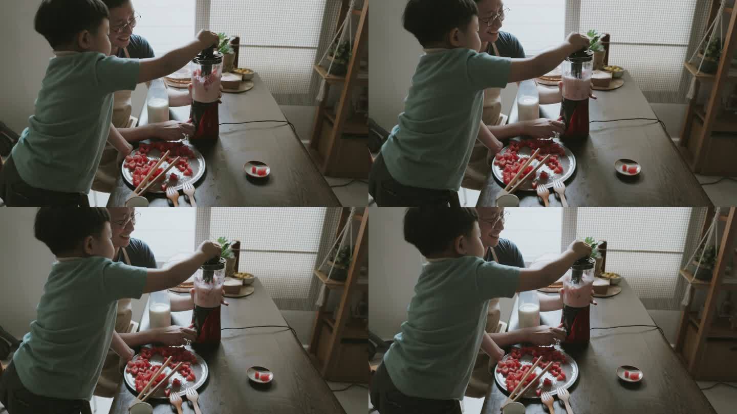 可爱的亚洲男孩拿着搅拌机搅拌西瓜奶昔。