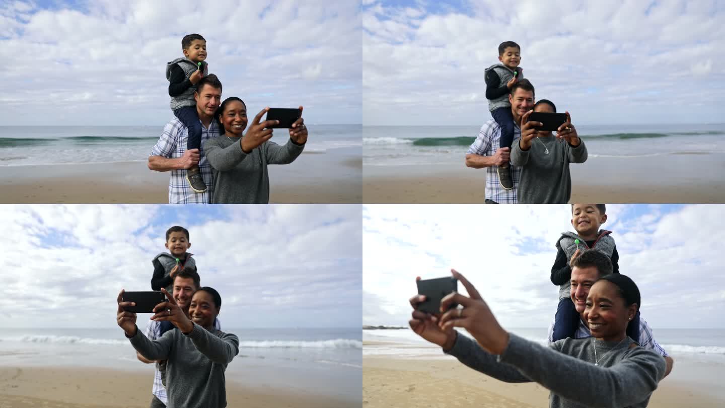 家庭使用智能手机在海滩上自拍