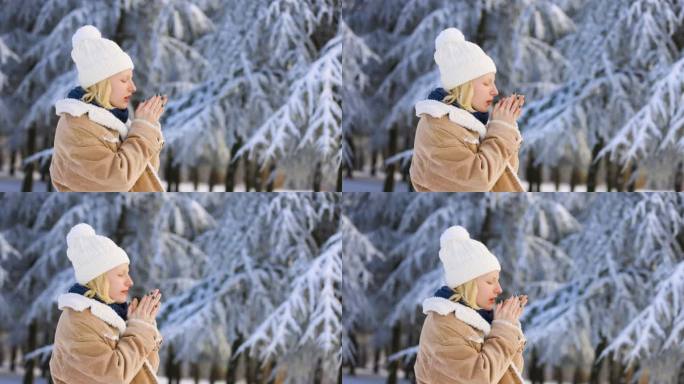 一个在白雪中冻僵的女人试图用手吹暖和自己