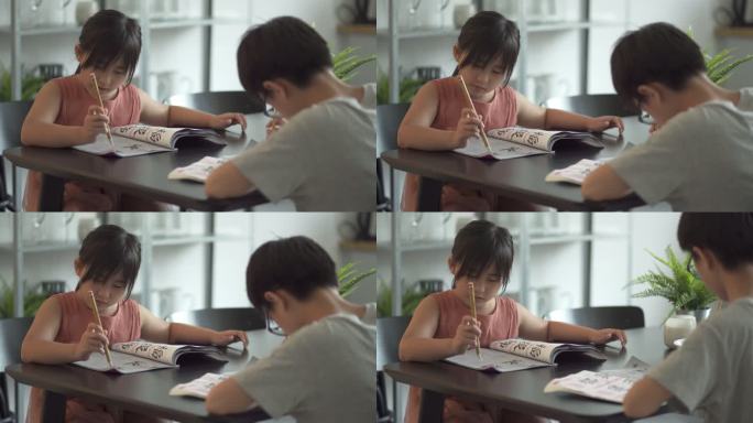 亚洲华人兄弟姐妹在家练习书法