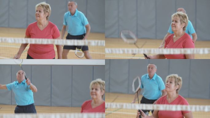 老年夫妇打双打室内羽毛球