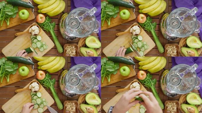 女性切割黄瓜以混合蔬菜和水果以制作排毒奶昔的镜头正上方的慢动作。