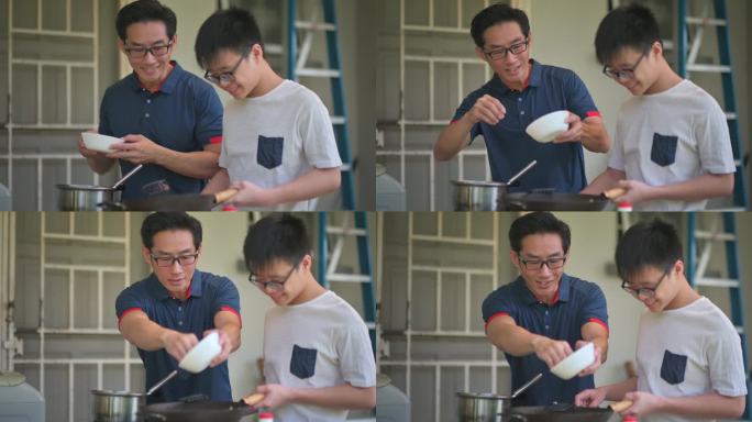 周末，亚裔中国父亲在潮湿的厨房后院教儿子做饭准备晚餐