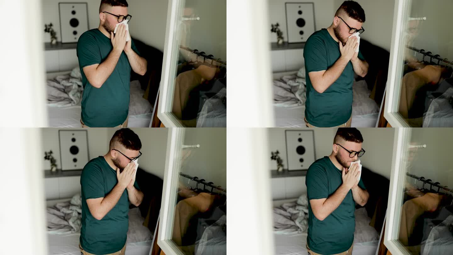 年轻人在卧室里擤鼻涕，一个流感男子在纸巾里打喷嚏。