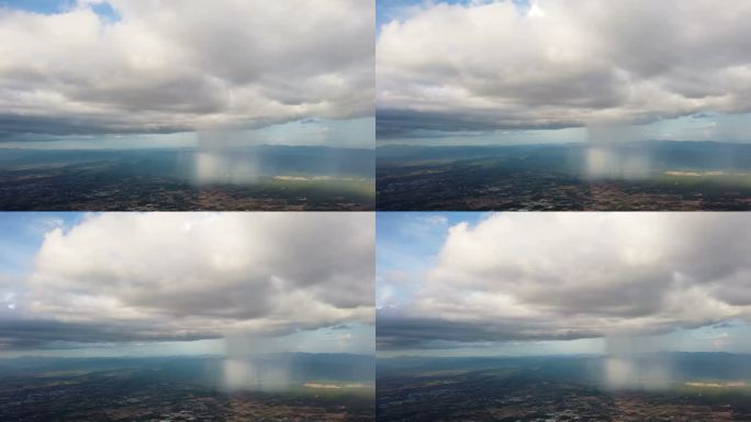 在云天和雨滴笼罩的飞机上从窗口观看风景