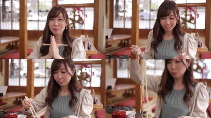 一位年轻女子在日本餐厅祈祷并吃着荞麦作为午餐