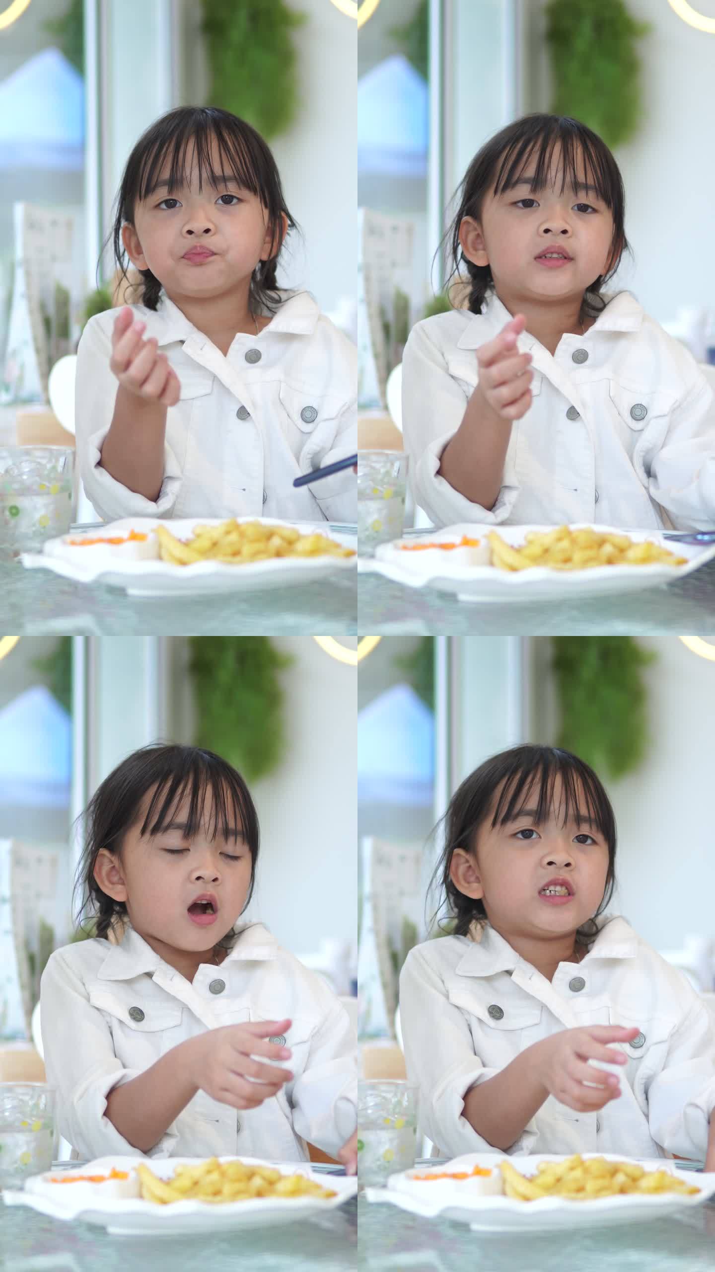 画像小女孩在餐厅吃薯条