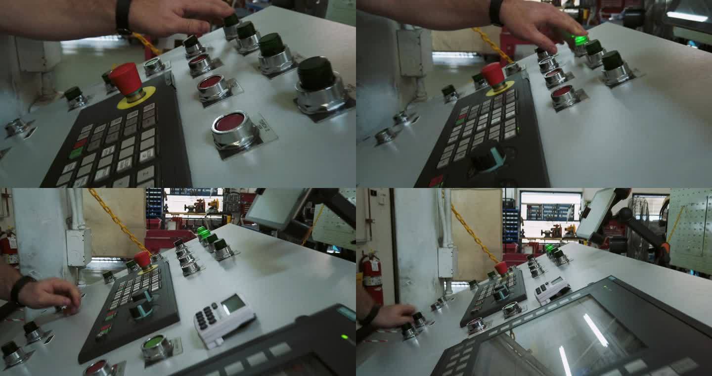 一位30多岁的白人技师在室内制造设施中按下按钮和控制装置