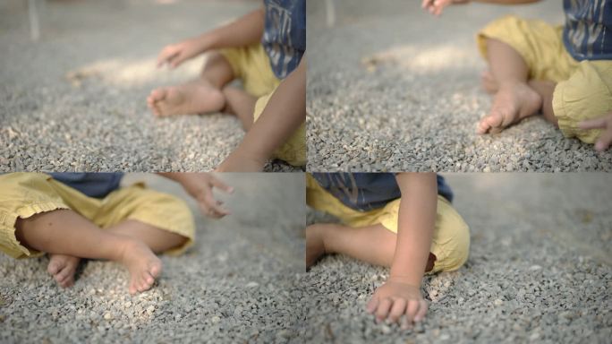 小男孩在操场上玩沙子。