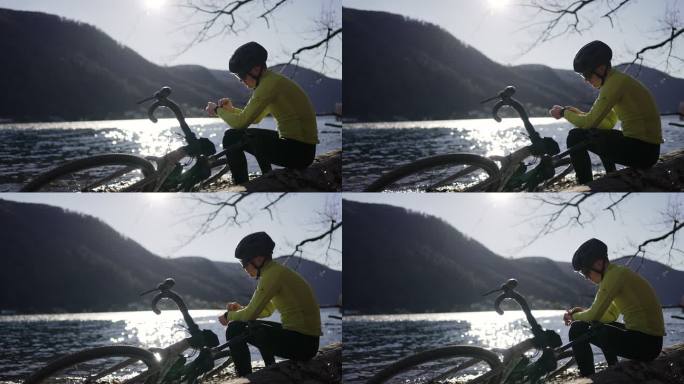 骑自行车的人在湖边休息，眺望风景