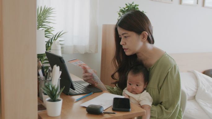 母亲在家用笔记本电脑检查财务