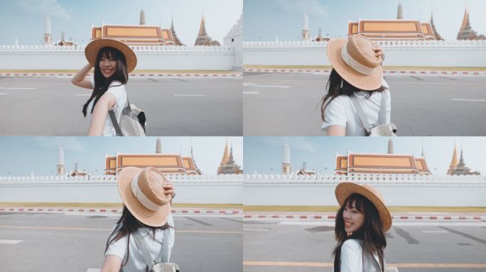 在曼谷的Wat Phra Kaeo，一位快乐的亚洲年轻女子牵着男友的手旅行