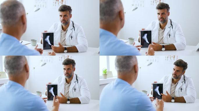 男医生给病人看脚的X光照片。
