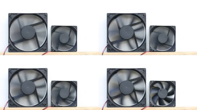 冷却两台不同尺寸计算机的黑色风扇的特写镜头。