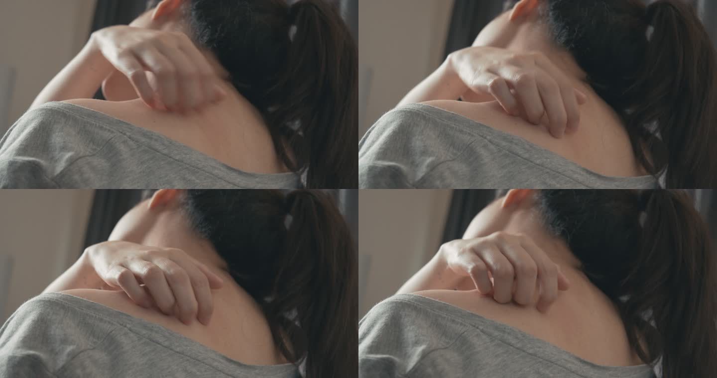 4k分辨率亚洲女人用手在他发痒的脖子上搔痒。医疗保健和医疗概念。湿疹皮肤