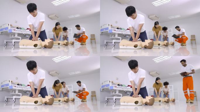 学生学习如何使用CPR玩偶和救生医学的概念，在CPR培训班中抢救紧急情况下的患者。